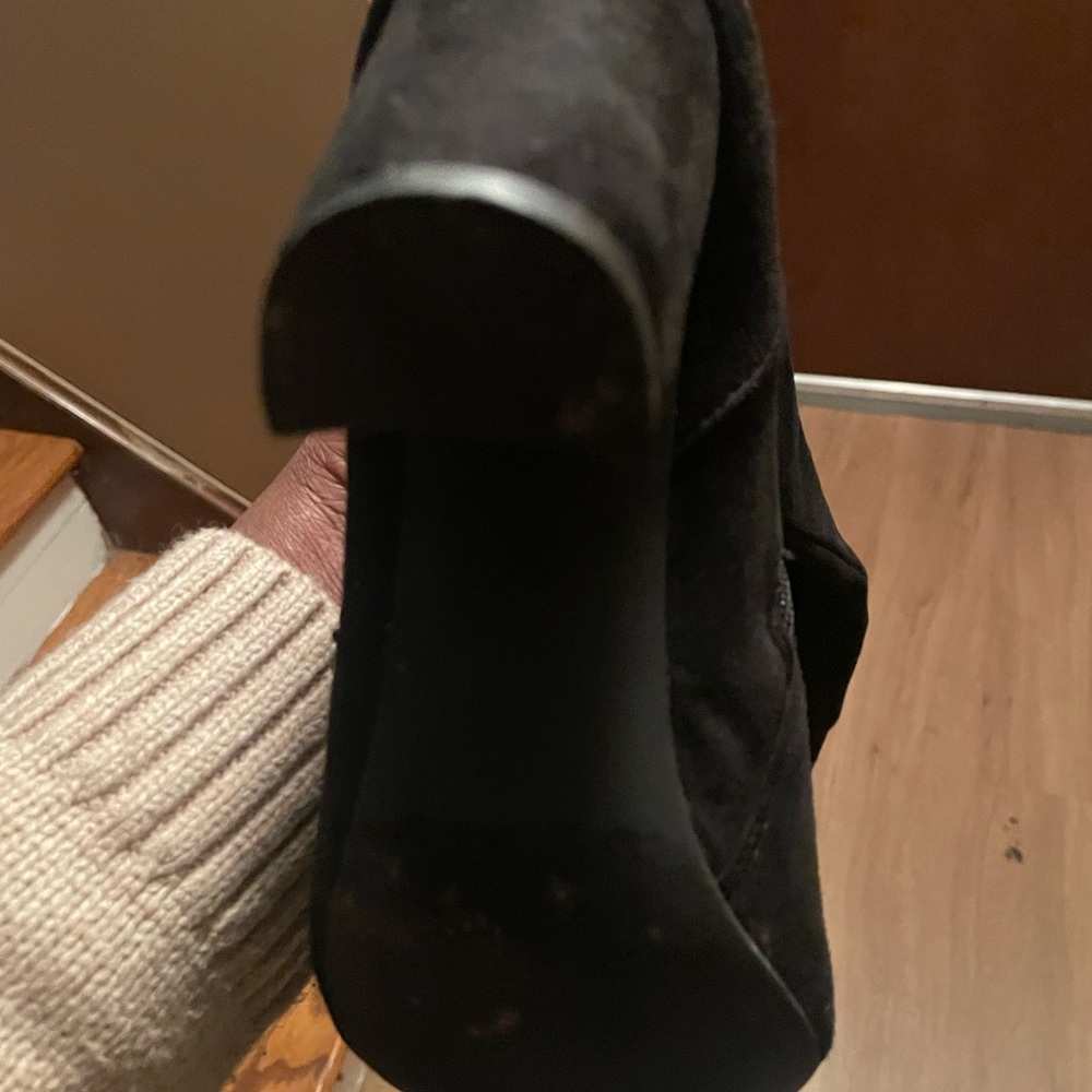 Black suede thigh boots.